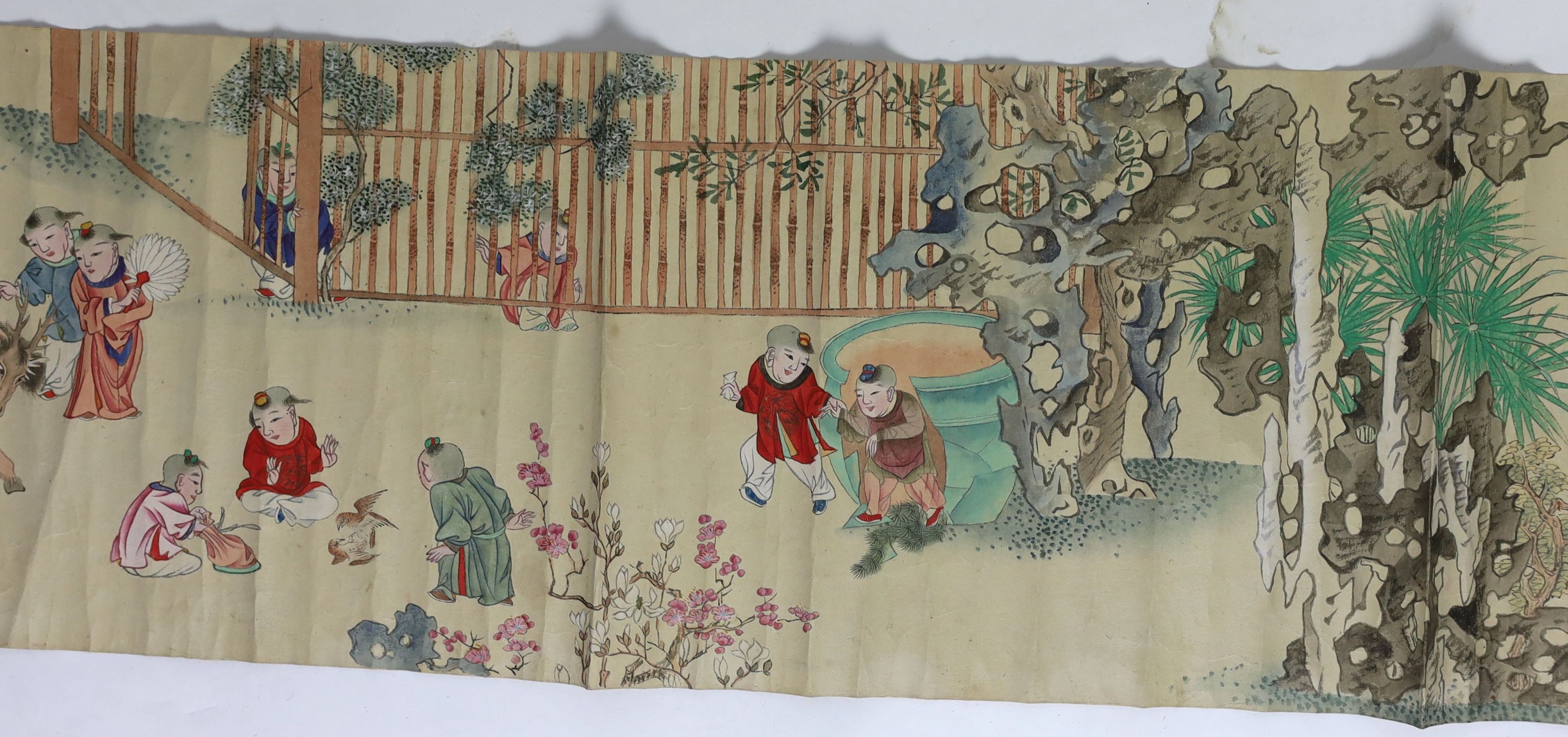A Chinese handscroll painting on paper of ‘Hundred boys’ in a garden, late Qing dynasty, image 570cm x 26cm